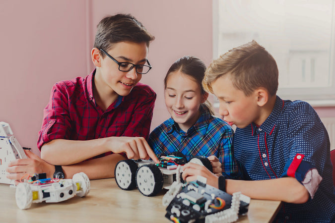 coding camps london - Children creating robots at school