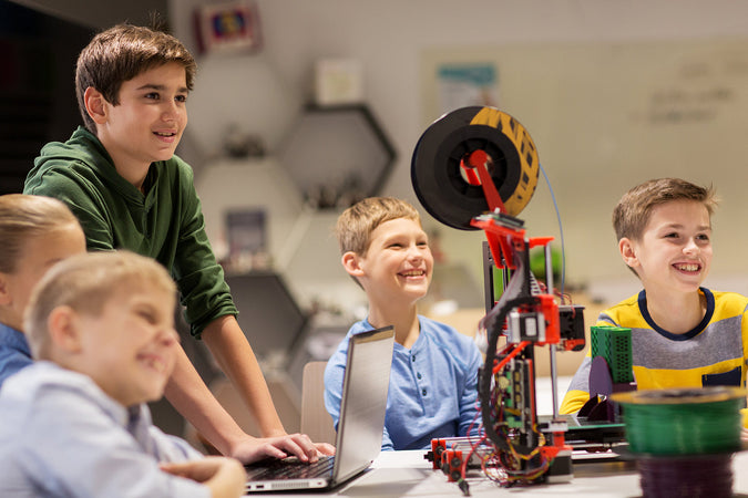 easter holiday camps london - group of happy kids with 3d printer